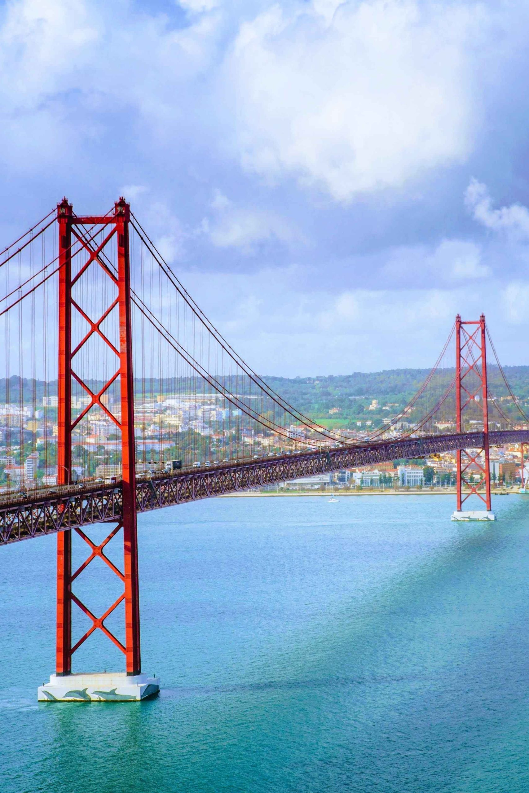 Beautiful scenery of the 25 de Abril bridge in Portugal under the breathtaking cloud formations